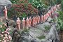 Statues of monks represented waiting in line for alms in the gardens of Dambulla's Golden Temple.