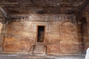 Badami: inside of a cave with many fine carvings, note the erosion patterns on the wall