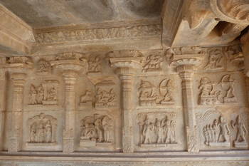 Hampi: bas relief in the Hazara Ramachandra temple with very detailed sculptures. Note the guys aiming at each other with bow and arrow and the wheeled war chariots.