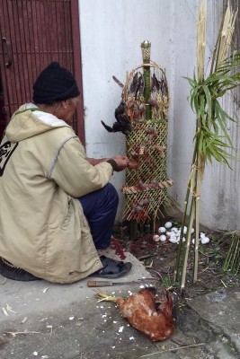 The Shaman in front of the house performing his ritual.