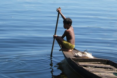 Boy on his boat on the Tonle Sap, Cambodia.