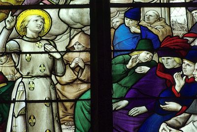 Stained-glass window from the church Notre-Dame la Grande in Poitiers representing Jeanne facing her examinators in Poitiers .
