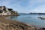 Along the promenade du Clair de Lune in Dinard. Saint-Malo can be seen in the background. A cruise ship is anchored in the bay.