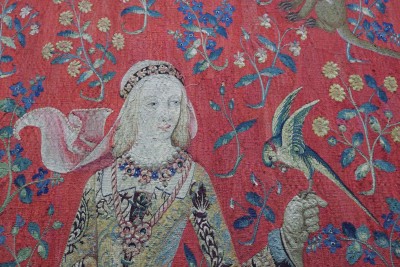 Detail of the tapestry dedicated to taste: the lady feeding her parakeet with a sugared almond.