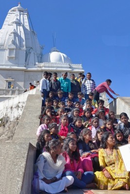 A group of children posing for a group photo on the stairs leading to the main temple...
