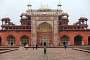 Akbar's mausoleum: after passing through the Buland Darwaza, a large paved path leads to the 22.5 m high four-tiered tomb. The monument is square and each side has the same design with a tall central gateway. The gateway on the southern side (on this picture) leads to a chamber from where a corridor goes down to the actual underground tomb chamber. The smaller doors right and left of the central gateway lead to tombs of members of the Imperial family. Only the ground level storey is open to the public. The white marble upper storey contains Akbar's ornate cenotaph, not visible to the public.