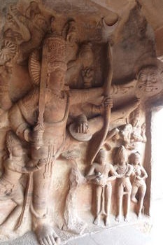 Badami: sculpture from one of the caves showing Trivikrama, an incarnation of Vishnu, fighting a demon.