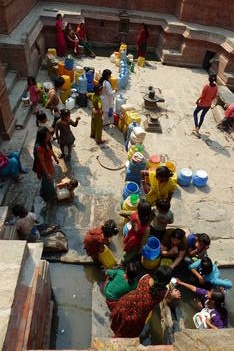 Kathmandu: people waiting for water at one of the traditional tanks.