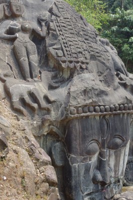 Rock sculptures of Unakoti: the Goddess Durga standing on the bull Mahishasura she has slayed. There is a bas-relief of Shiva below her.