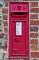 Arundel, West Sussex: a wall box with the cypher VR for Victoria Regina. There are still many VR post boxes around, they have been put up between 1853 and 1901, the end of her reign. This box has seen many layers of paint!