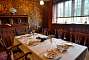 The dining room. The walls are decorated with embossed leather wall hangings, inspired by Indian chintz designs. They are covered with silver leaf and then varnished to make them glisten like gold.
