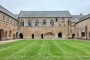 The cloister is still enclosed on all four sides, the building in front is the refectory. The large arch outside the ground floor of the refectory is what remains of the abbey's laver.