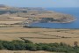 Kimmeridge Bay in the foreground, Clavell Tower on its eastern end and St Adhelm's Head in the background.