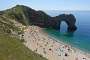 The emblematic Durdle Door on a busy June day in 2021.