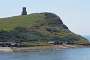 The folly of Clavell Tower built above the east end of Kimmeridge Bay. The part of the beach below is out of bound (see the red flag). The tower was built in about 1830 by Reverend John Richards Clavell as an observatory and folly. Threatened by erosion it was moved back 25 metres from the crumbing cliff edge in August 2006.