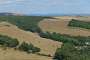 Back inland to rejoin Kingston, view over the Encombe estate on the bottom right with an obelisk left on the ridge. The white cliffs of the Isle of Wight are clearly visible on the horizon (August 2022).