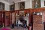 Inside the mansion house: the hall. The motto on the fireplace reads: Fear God, Honor the King.