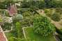 Another view of the garden with Priest's House cottage located on the edge of the Delos Garden. It is believed to have been part of the former Elizabethan mansion and is now rented by National Trust as holiday cottage.